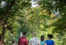 부모와 자녀의 건강한 관계 만들기 man in red t-shirt and gray pants holding hands with boy in blue t-shirt