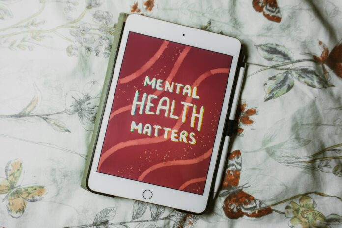 Photo by Emily Underworld a tablet with the words mental health matters on it