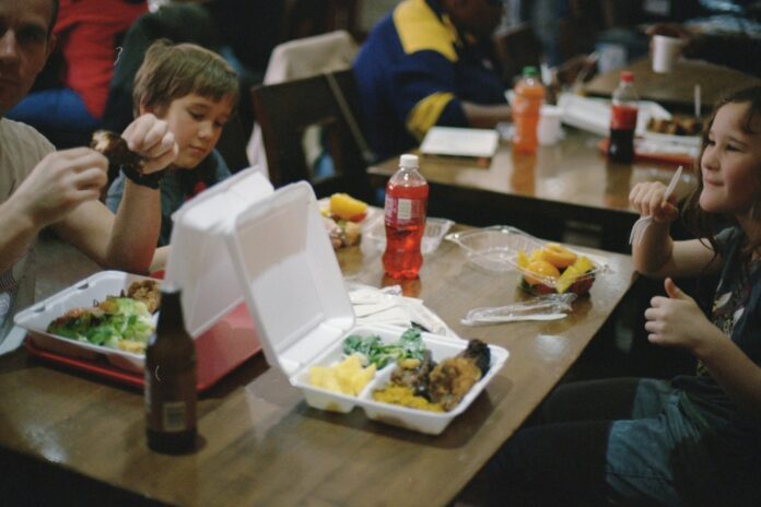 Photo by Annie Spratt two children sitting beside dining table