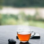 “나를 위한 건강 루틴, 여성의 일상에서 실천하는 새로운 트렌드” a cup of tea and a cell phone on a table